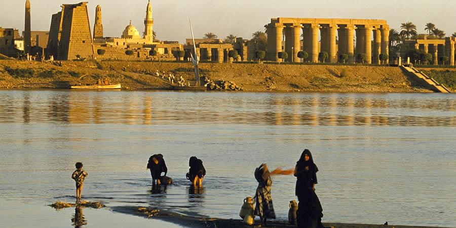 Women and children fetch water at the banks of river Nile. For decades, the Nile has been the main source of water for Egypt. Untill now, families fetch water from the riverbank. Photo Credit: David Boyer - www.nationalgeographic.org